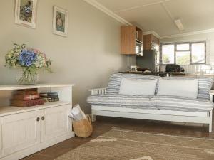 a living room with a couch and a vase of flowers at Winford Manor in Murdoch Valley