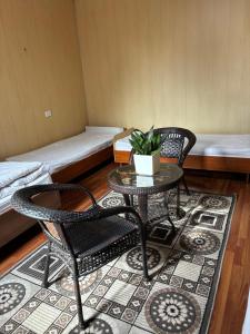 a room with two chairs and a table and a couch at Жетиген in Karakol