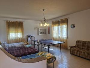 a living room with a ping pong table and a couch at Villa Giù, indipendent villa near airport and sea in Cinisi