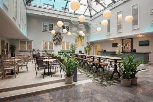 a restaurant with tables and chairs in a room at Scandic Neptun in Bergen