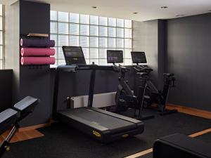 a gym with two exercise bikes and a treadmill at Numa Cologne Ehrenfeld in Cologne