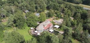 an overhead view of a large house in the woods at Outdoors Holten - Cabin Skydeck in Holten