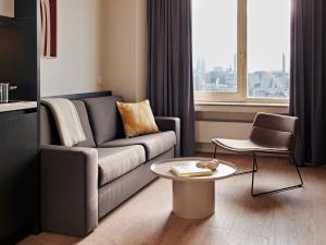 a living room with a couch and a table at Numa Cologne Ehrenfeld in Cologne +39 photos