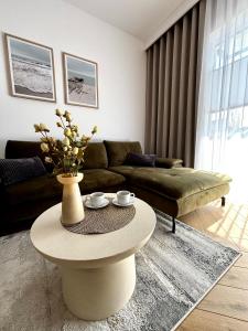 a living room with a couch and a coffee table at Apartament Kaszubska Bryza III - HEL in Hel