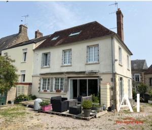 a large white house with a lot of windows at Le gîte de la Roche in Putanges