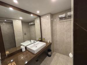 a bathroom with a sink and a mirror at Hotel Residency in Jalandhar