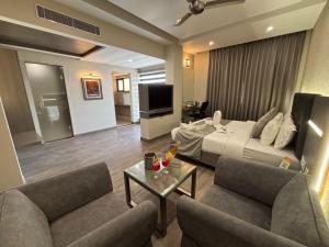 a hotel room with a bed and a living room at Hotel Residency in Jalandhar
