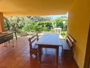 a wooden table and chairs on a patio at Villa Giù, indipendent villa near airport and sea in Cinisi +17 photos