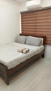 a bedroom with a bed with a wooden headboard at Mi Casa Nova in Bacolod +23 photos