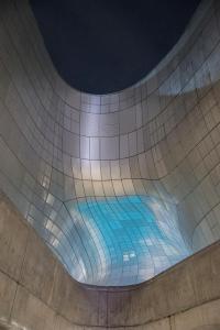 a swimming pool with blue water in a building at D-Haus Hostel Dongdaemun in Seoul