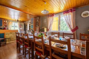 a dining room with a long table and chairs at Gîte forestier du Moulin - 10 pers in Raon-sur-Plaine