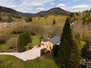 an aerial view of a house in the mountains at Gîte forestier du Moulin - 10 pers in Raon-sur-Plaine