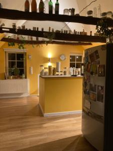 a kitchen with a counter and a yellow wall at Charmantes und geräumiges Loft im DG eines Fachwerkhauses in Dortmund