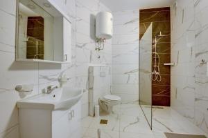 a bathroom with a sink and a toilet and a shower at Beach Apartments in Ulcinj