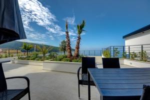 a patio with a table and chairs and the ocean at Beach Apartments in Ulcinj
