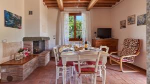 a dining room with a table and a fireplace at Petriolo - Tuscany Hills & Jacuzzi in Cerreto Guidi
