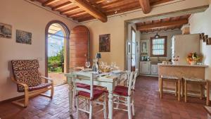 a kitchen and dining room with a table and chairs at Petriolo - Tuscany Hills & Jacuzzi in Cerreto Guidi