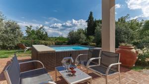 a patio with chairs and a swimming pool at Petriolo - Tuscany Hills & Jacuzzi in Cerreto Guidi