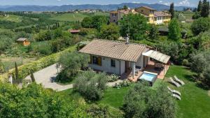 an aerial view of a small house in a field at Petriolo - Tuscany Hills & Jacuzzi in Cerreto Guidi