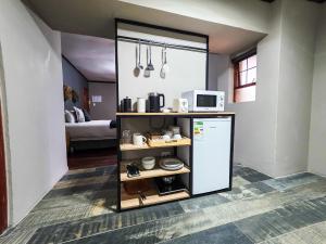 a kitchen with a refrigerator and a microwave at 440@Brooklyn in Pretoria
