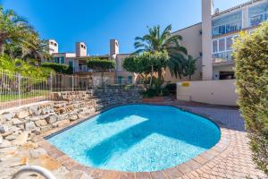 a swimming pool in front of a building at Zenith Place, Port St Francis in Cape St Francis