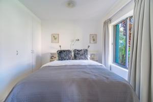 a bedroom with a bed and a window at Zenith Place, Port St Francis in Cape St Francis