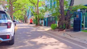 a white van parked on the side of a street at Tejas 4 Bhk Villa in Pune