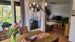 a living room with a table and a dining room at Apartment in Flensburg