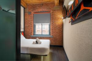 a small room with a bed and a window at easyHotel Manchester in Manchester
