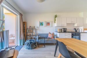 a living room with a table and a kitchen at Zenith Place, Port St Francis in Cape St Francis
