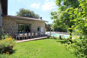 a garden with a swimming pool and a house at La couze in Razès