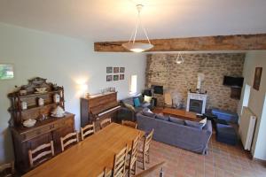 a living room with a couch and a dining room at La couze in Razès
