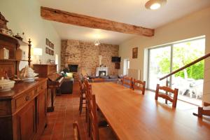 a kitchen and living room with a table and chairs at La couze in Razès
