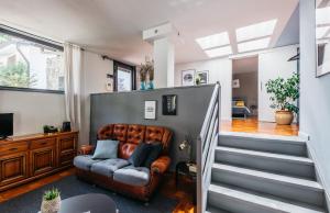 a living room with a couch and stairs at Villa Pegasus in Turin