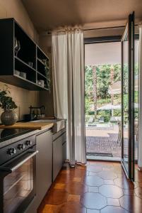a kitchen with an open door to a patio at Villa Pegasus in Turin