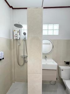 a bathroom with a shower and a sink and a toilet at Laydee Resort in Chumphon +44 photos