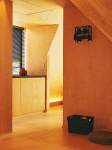 a room with an orange wall with a radio on the wall at Kokage Villa Nikko-KVN in Nikko