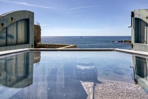 a swimming pool with a view of the ocean at Loft Calella de Palafrugell in Calella de Palafrugell