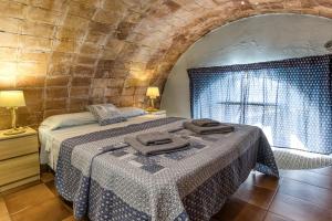 a bedroom with a bed with two towels on it at Loft Calella de Palafrugell in Calella de Palafrugell +20 photos