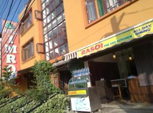 a store with a sign in front of a building at Hotel imroz in Srinagar