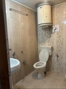 a bathroom with a toilet and a sink at Hotel imroz in Srinagar