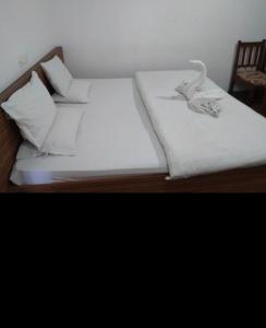 two beds in a room with white sheets and pillows at Hotel imroz in Srinagar +23 photos