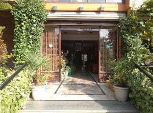 an entrance to a building with potted plants at Hotel imroz in Srinagar