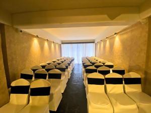 a room with rows of white chairs in a theater at Evri Hotel & Resorts in Lava