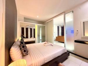 a bedroom with a bed with two giraffes on it at Westkey Kamala Hotel in Kamala Beach +26 photos