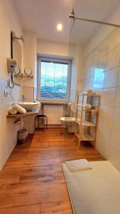 a bathroom with a sink and a toilet and a window at Fischerhof Agriturismo in Cornaiano +30 photos