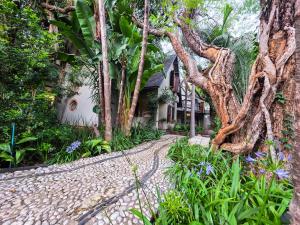 a cobblestone path in front of a house with trees at 440@Brooklyn in Pretoria