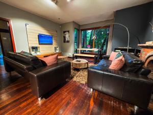 a living room with two leather couches and a table at 440@Brooklyn in Pretoria