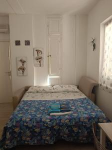 a bedroom with a bed with a blue blanket at La conchiglia in Motta San Giovanni