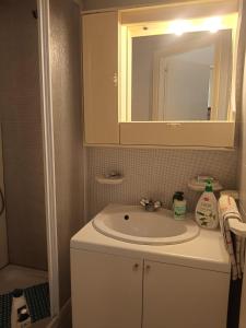 a bathroom with a sink and a mirror at La conchiglia in Motta San Giovanni